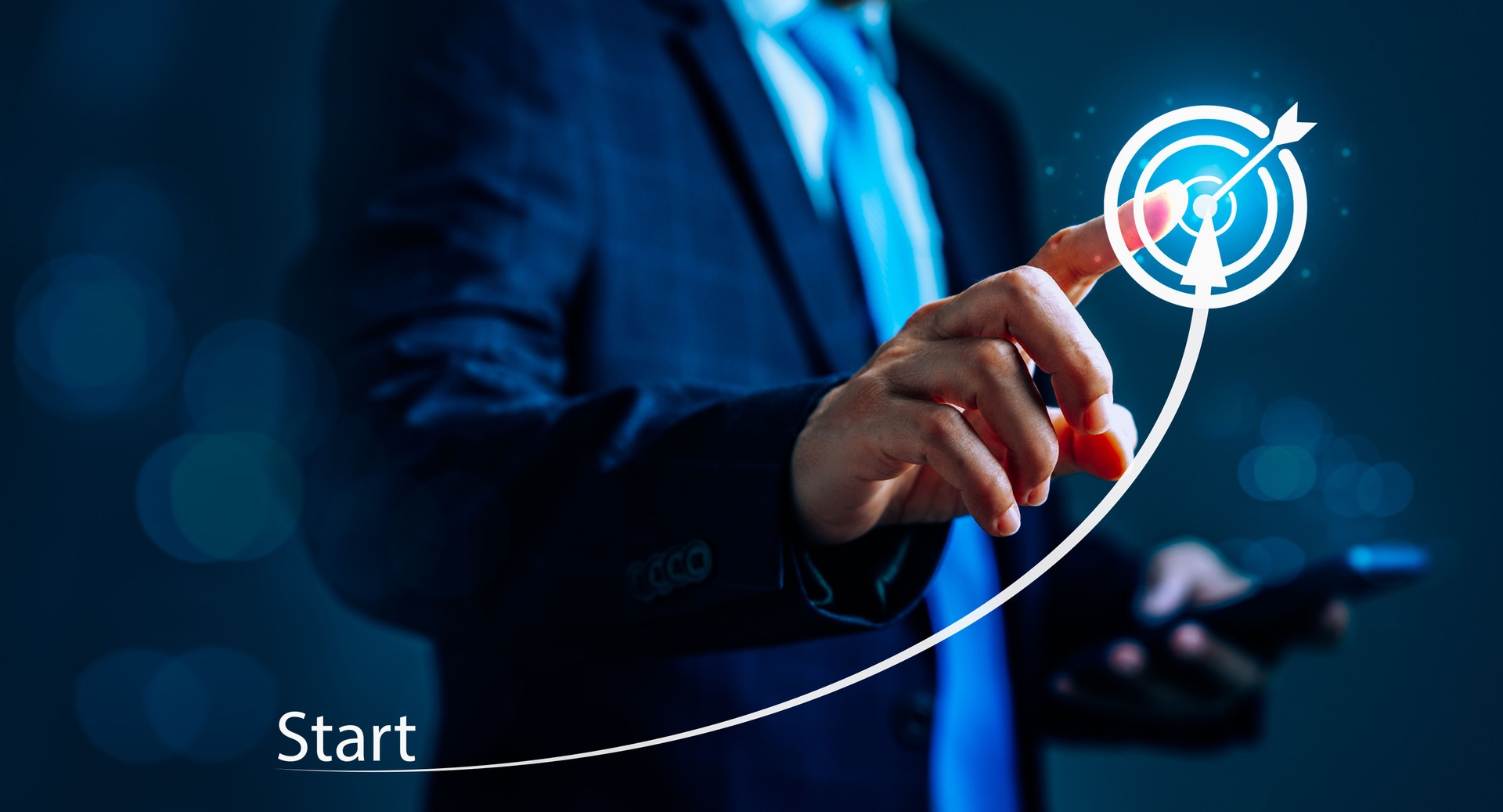 Businessman standing in front of a chart or graph, pointing to an arrow that indicates growth